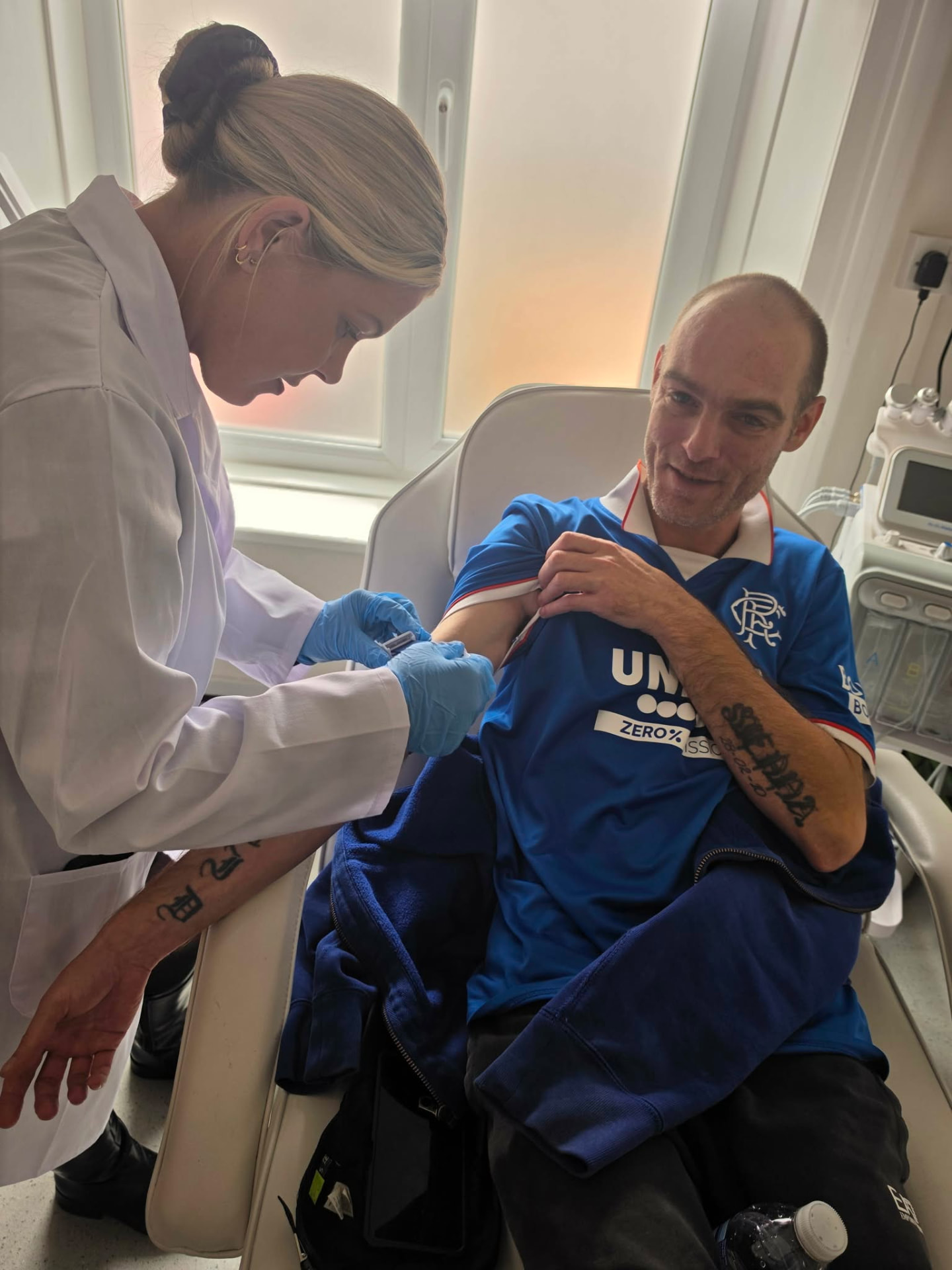 A practitioner preparing a client for treatment in the Hereford clinic